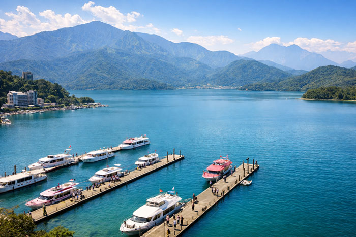 Shuishe Pier on Sun Moon Lake with boats and mountain landscape Taiwan